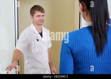 Woman entering doctor`s office in modern clinic Stock Photo